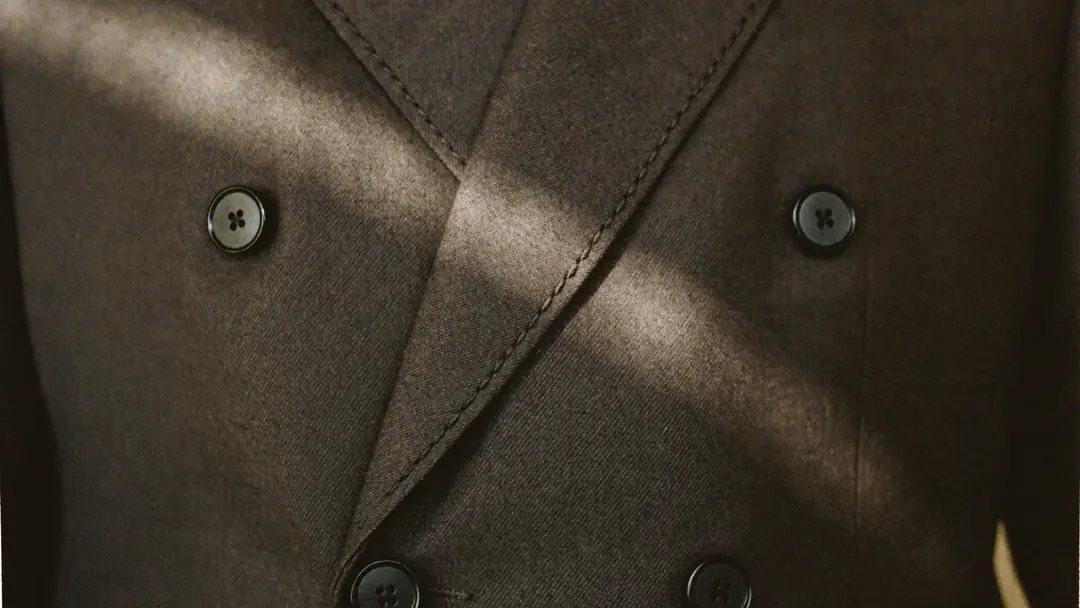 Close view of a double-breasted blazer in soft window light